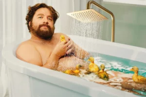 économiser l'eau dans la salle de bains. Un homme dans sa baignoire gourmande en eaux